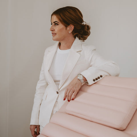 Mel Hornery in her skin care clinic, Mel Hornery Cosmetics, consulting with a client amidst elegant, calming decor.