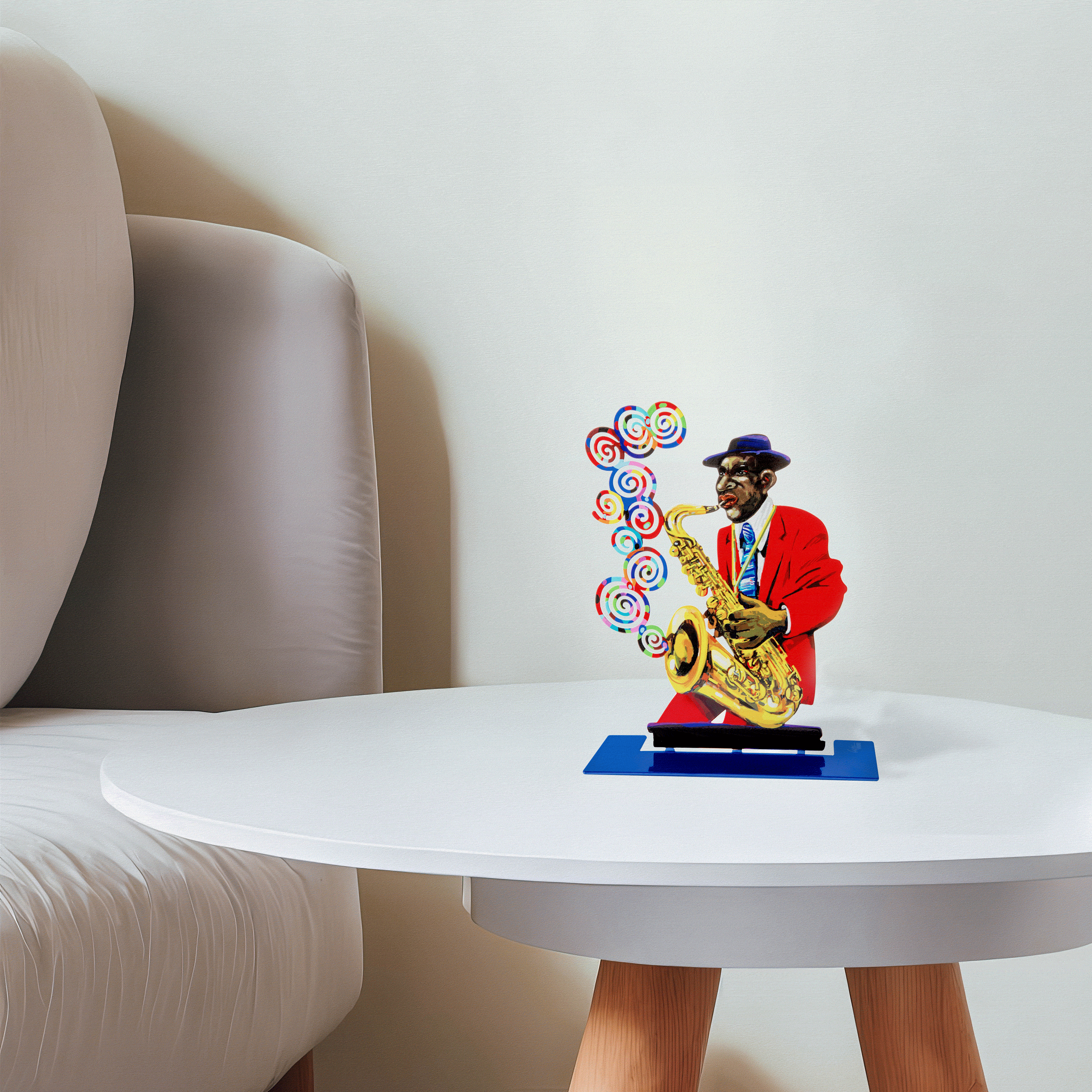 metal sculpture of a man playing the saxophone sits on a whit etable next to a white couch
