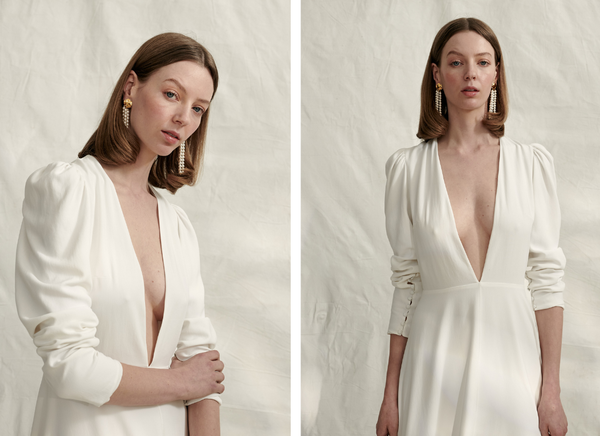 woman wears long sleeve plunge neckline crepe wedding dress with ruched sleeves and midi length