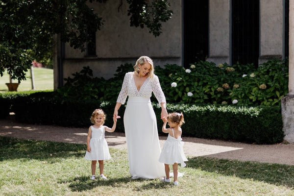 older bride wears beautiful french lace wedding dress with daughters