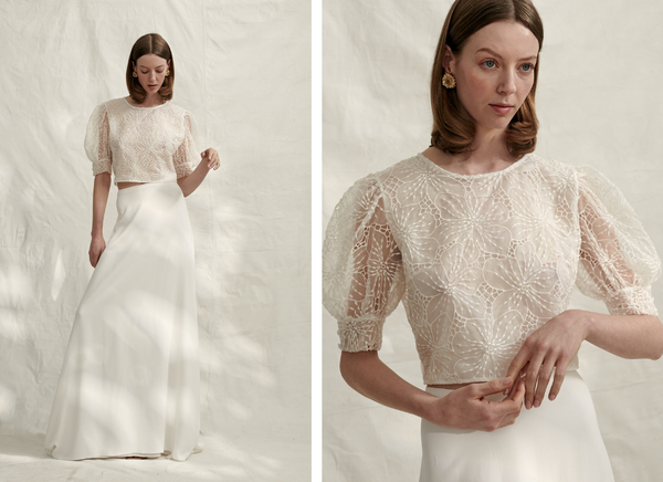 Woman wearing Donatelle Godart embroidered organza top with puffy sleeves and floor length white wedding skirt
