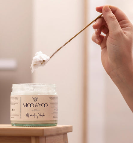 hair mask being spooned out of jar