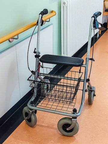 Traditional Four Wheel Rollator With Basket and Hanging Wires In Corridor