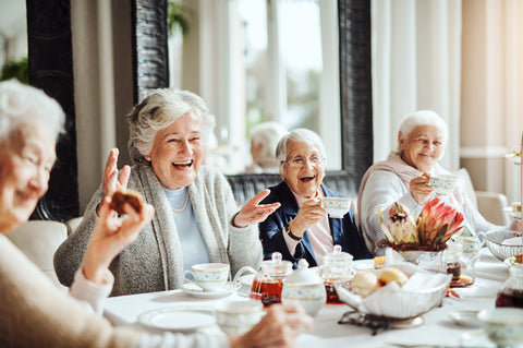 happy senior women having tea together at a cafe. Socialising is fun.