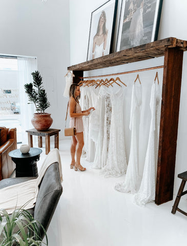 a bride wedding dress shopping at a bridal boutique