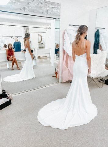 a bride at her appointment getting her wedding dress alterations