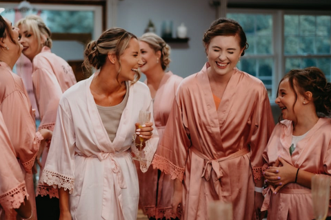 Maid of Honor laughing next to the bride on her wedding day