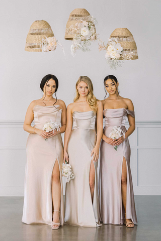 three bridesmaids wearing satin neutral champagne bridesmaid dress from birdy grey