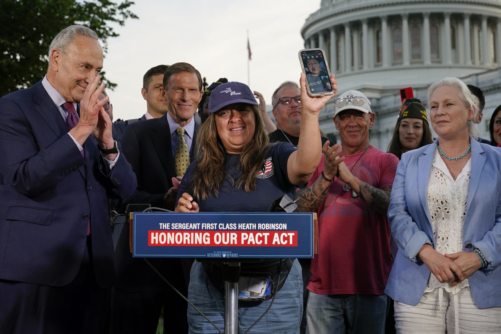 Senate Swamp --  On August 2, 2022, Rosie Torres has Le Roy Torres on Facetime during a press conference with Sen. Schumer and Sen. Gillibrand following the final passage of the PACT Act.