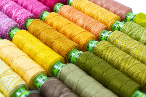yellow and green thread spools