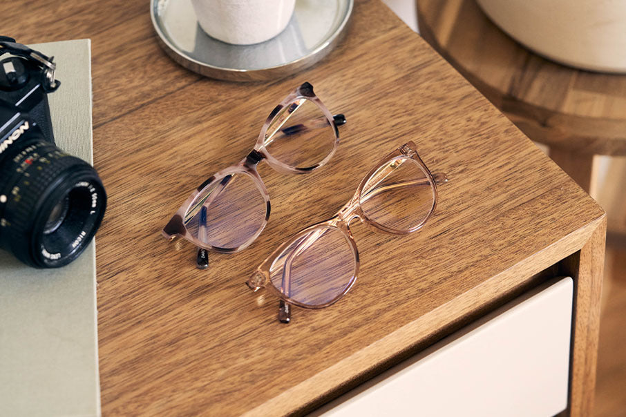 Two DIFF Eyewear Glasses on a table