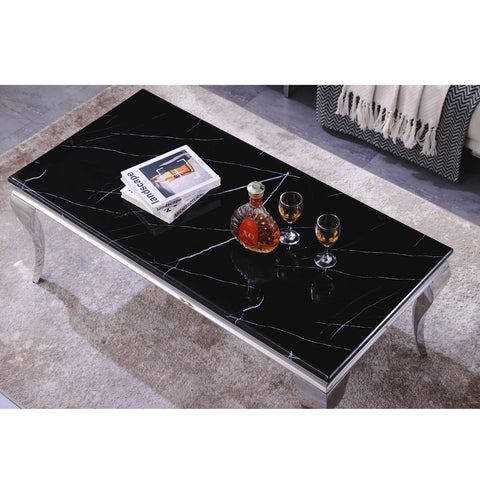 Title: The Modern Elegance of a Black Coffee Table: Benefits and Style  Subtitle: How a Black Coffee Table Can Elevate Your Living Room Decor  Coffee tables are an essential piece of furniture in any living room. They not only serve a practical purpose but also add to the overall aesthetic of the space. If you are looking for a coffee table that is both functional and stylish, a black coffee table may be the perfect choice for you.  The Benefits of a Black Coffee Table  Versatile Design One of the biggest advantages of a black coffee table is its versatility. Black is a neutral color that can complement any existing decor style, whether it be modern, traditional, or eclectic. This means that you can easily change up the look of your living room without having to replace your coffee table.  Creates a Focal Point A black coffee table can act as a focal point in your living room. The sleek and sophisticated design of a black coffee table draws the eye and can make a statement in any space. It also provides a perfect backdrop for decorative items such as books, candles, or plants.  Reflects Light A black coffee table with a silver mirror frame, like the one described above, can reflect light and make your living room appear brighter and more spacious. This is especially useful if you have a small living room or one with limited natural light.  Easy to Clean The metal trim tabletop of the coffee table described above is made of MDF and resin, which is sleek and easy to clean. This makes it a practical choice for families with children or pets, as spills and stains can be easily wiped away.  Style Tips for a Black Coffee Table  Pair with Light Colored Furniture To create a modern and chic look, pair your black coffee table with light-colored furniture such as a white sofa or beige armchairs. This will create a striking contrast and make your coffee table stand out.  Add Decorative Accents A black coffee table provides the perfect backdrop for decorative accents such as books, candles, or vases. Choose items that complement the color scheme of your living room to create a cohesive look.  Layer Textures To add depth and interest to your living room, layer textures on your black coffee table. This can be achieved by adding a textured rug underneath the coffee table or placing a woven basket on top.  Conclusion  A black coffee table is a versatile and stylish choice for any living room. It can act as a focal point, reflect light, and complement any existing decor style. By following the style tips above, you can create a modern, chic, and sophisticated living room that is both functional and beautiful.  There are many ways to decorate a black coffee table to complement your living room decor and personal style. Here are a few ideas:  Use Trays: Place decorative trays on your black coffee table to create an organized and cohesive look. You can use trays to hold books, candles, vases, or other decorative items.  Add Greenery: Incorporate plants or flowers into your coffee table decor for a natural and fresh touch. You can use a small potted plant or vase with fresh flowers to add color and texture.  Use Books: Stack books on your coffee table to create height and visual interest. Choose books with attractive covers that fit with your decor scheme.  Add Texture: Use decorative items with different textures such as a woven basket, a ceramic vase, or a wooden box to add depth and interest to your coffee table decor.  Incorporate Art: Place a small piece of art or a sculpture on your coffee table to add a personal and artistic touch to your living room.  Use Mirrors: Incorporate mirrors into your coffee table decor to reflect light and create the illusion of a larger space. You can use a mirrored tray or a decorative mirror to achieve this effect.  Add a Pop of Color: Use colorful decorative items such as a bright vase, colorful coasters, or a patterned tray to add a pop of color to your black coffee table and create a playful and cheerful look.