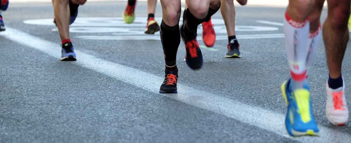 Runners wearing compression socks during a race.