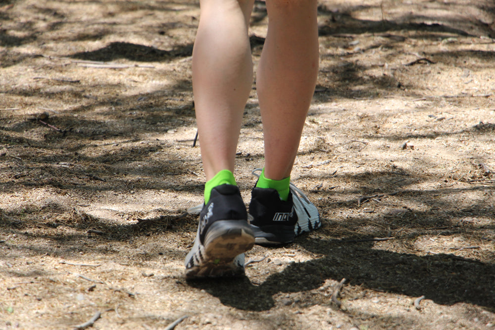 Running in the woods while wearing compression socks.