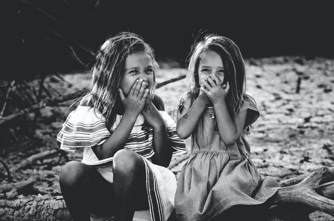 2 girls giggling in black and white