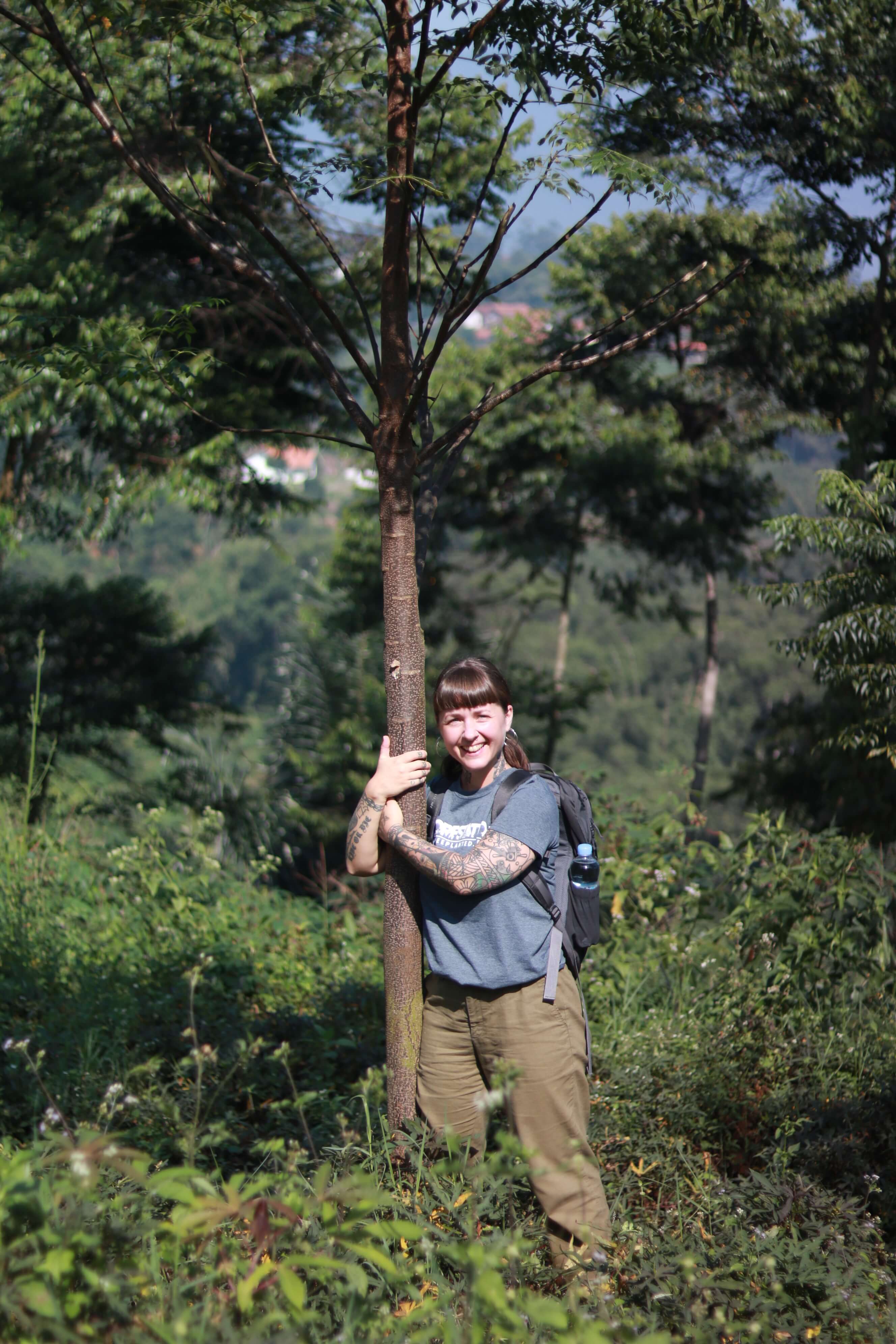 A woman hugging a tree with the One Tree Planted charity