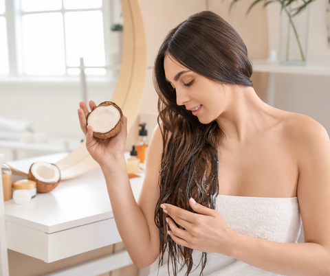 woman applying natural oil  on her hair