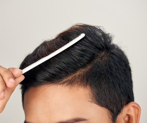 man brushing his hair