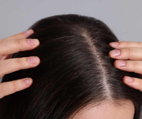 woman checking her scalp