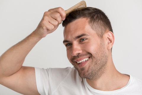 man brushing his hair