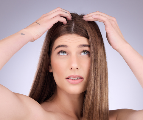 woman checking her head and scalp