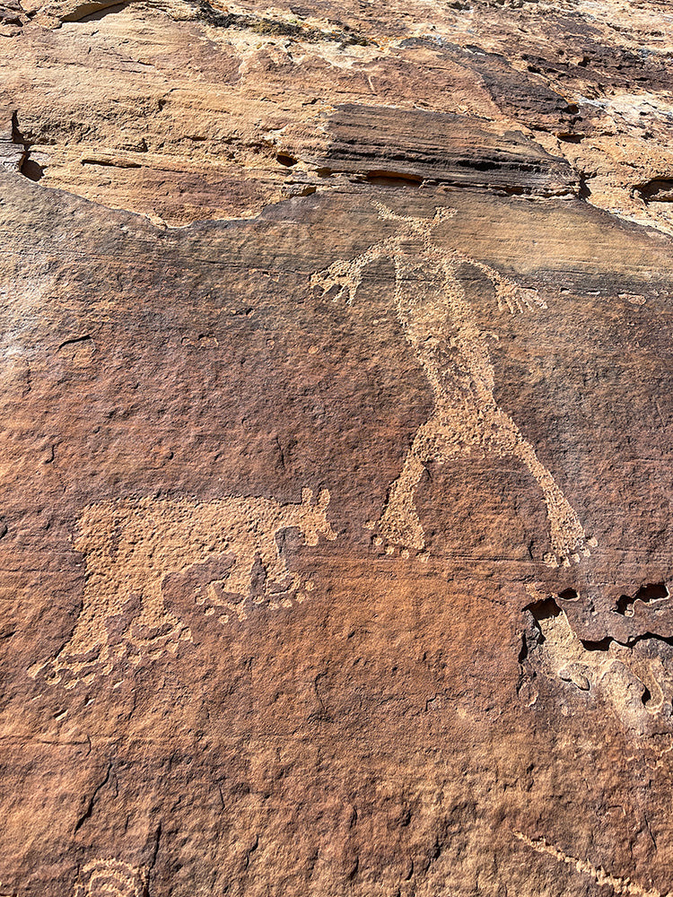 rock wall with petroglyph art drawings