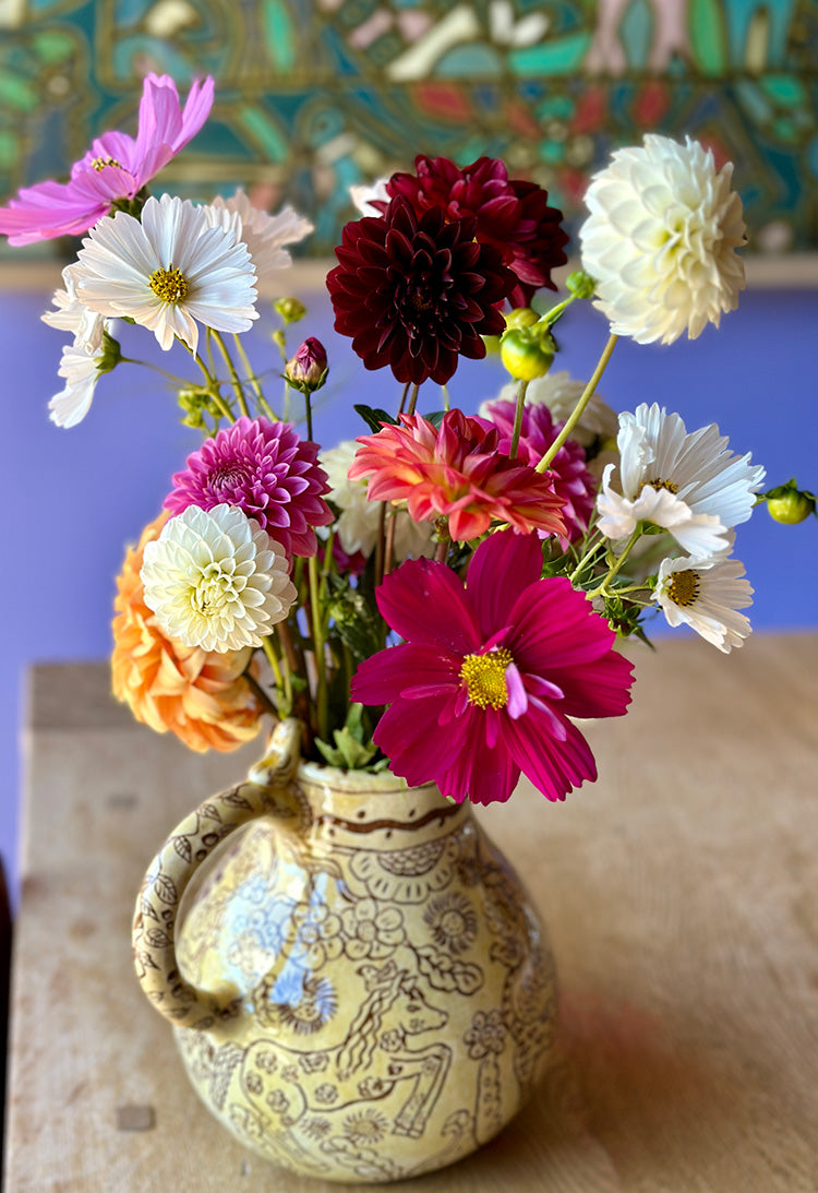colorful flower arrange in a handmade artistic vase
