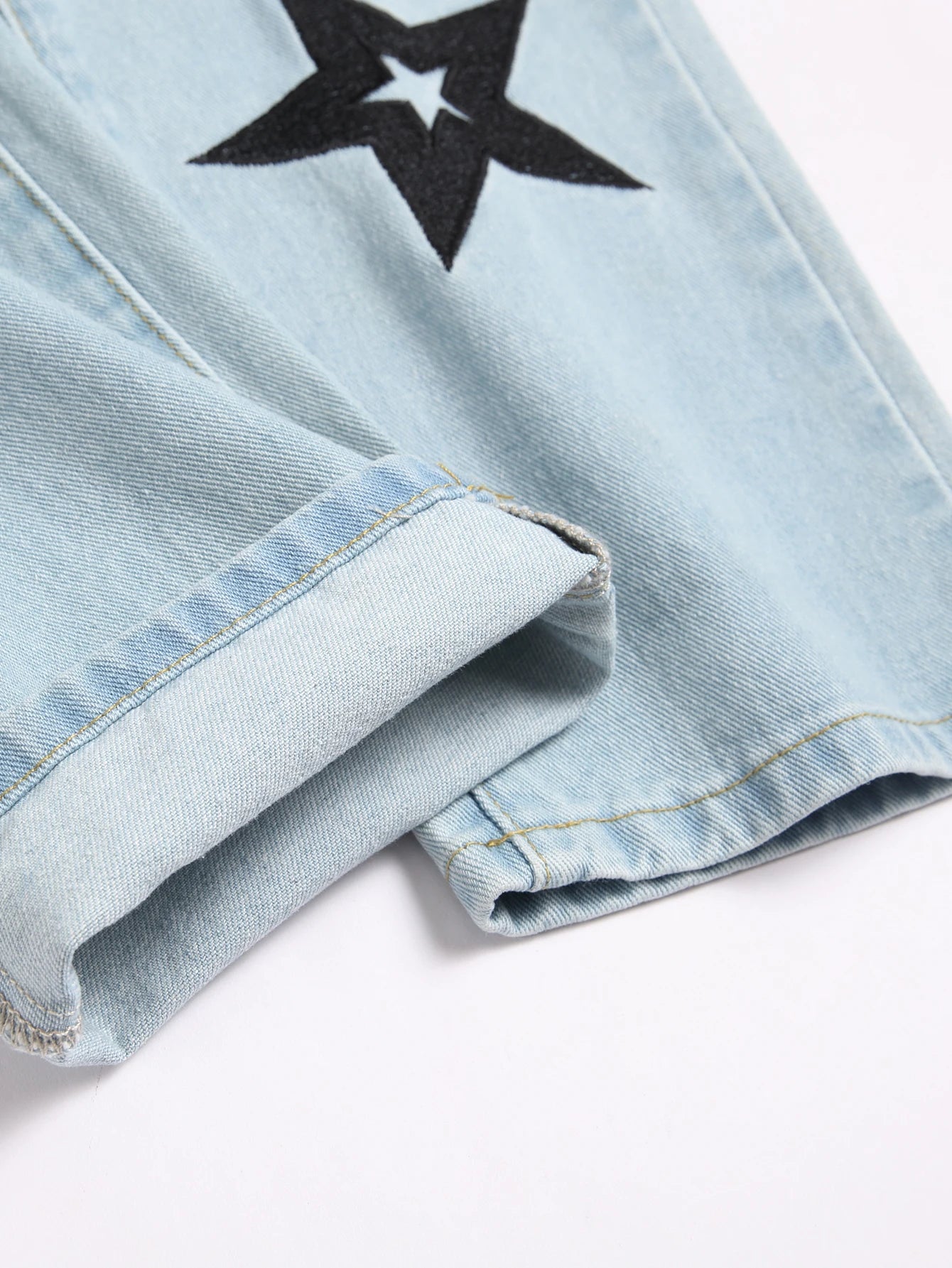 Detailed close-up of bottom hem stitching on Veydrik Starwave slim-fit jeans