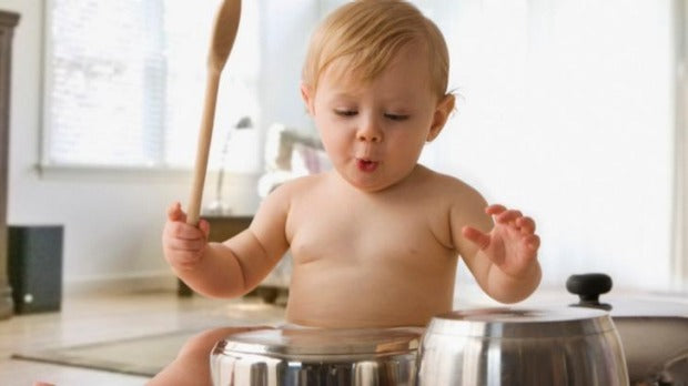 Baby entertained with homemade musical instruments