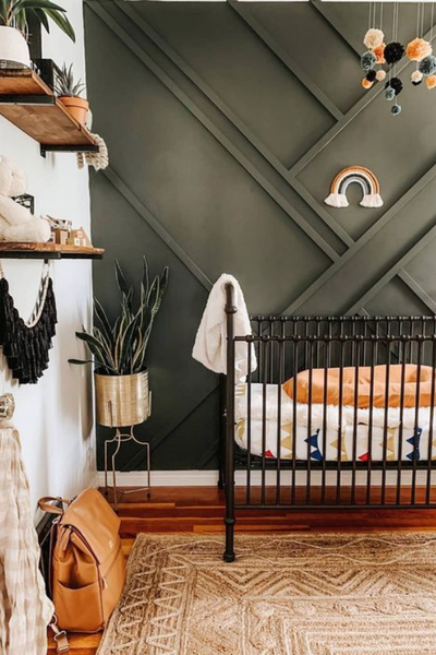 Green panelling baby bedroom