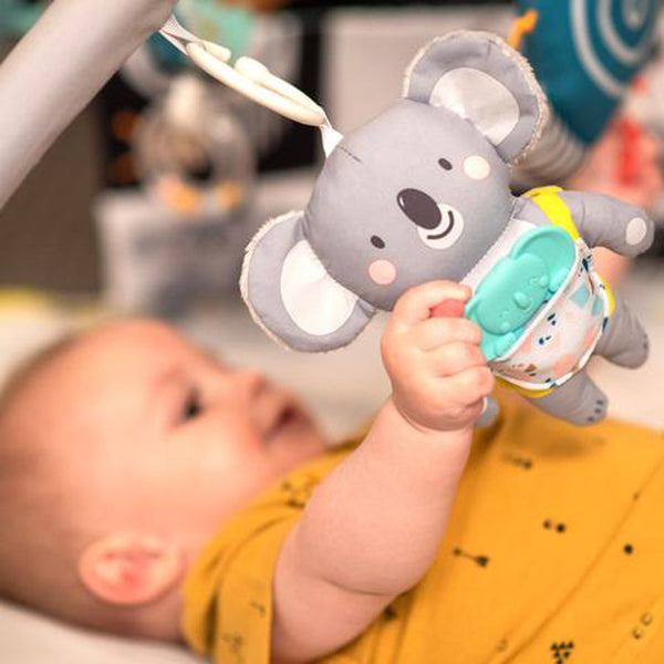 baby grapping a sensory toy