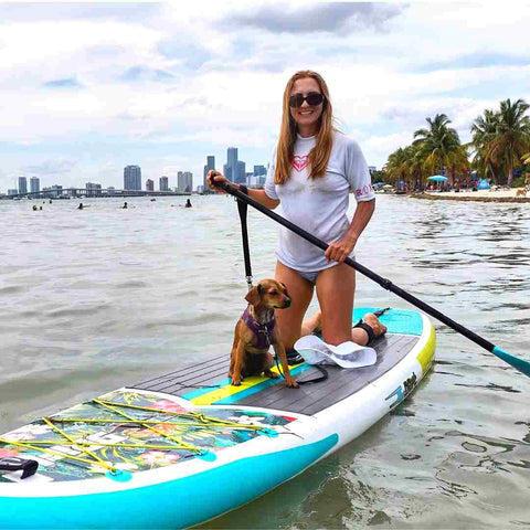 Green Vegan Bags owner paddleboarding with her puppy