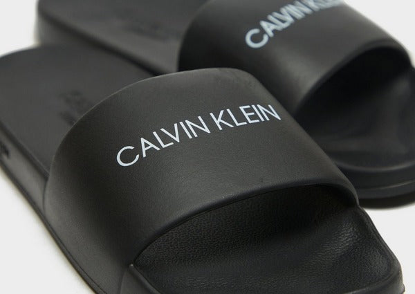 A picture showing our Script Logo Boys Pool Slides, Black - Part of the Calvin Klein Boys swimwear collection for SS21