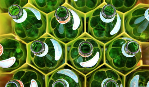 green glass bottles positioned in rows