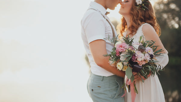 A bride holding a bouquet, representing the style of flowers