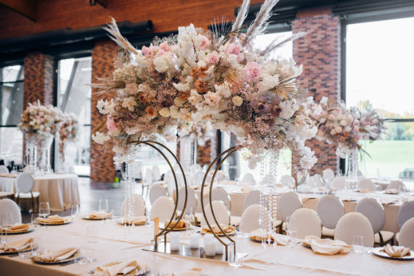 A beautifully decorated wedding reception with flowers as centrepieces