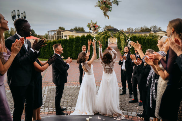 Brides throwing bouquet