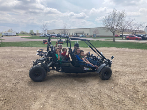The Victory Powersports Family enjoying a go kart ride.