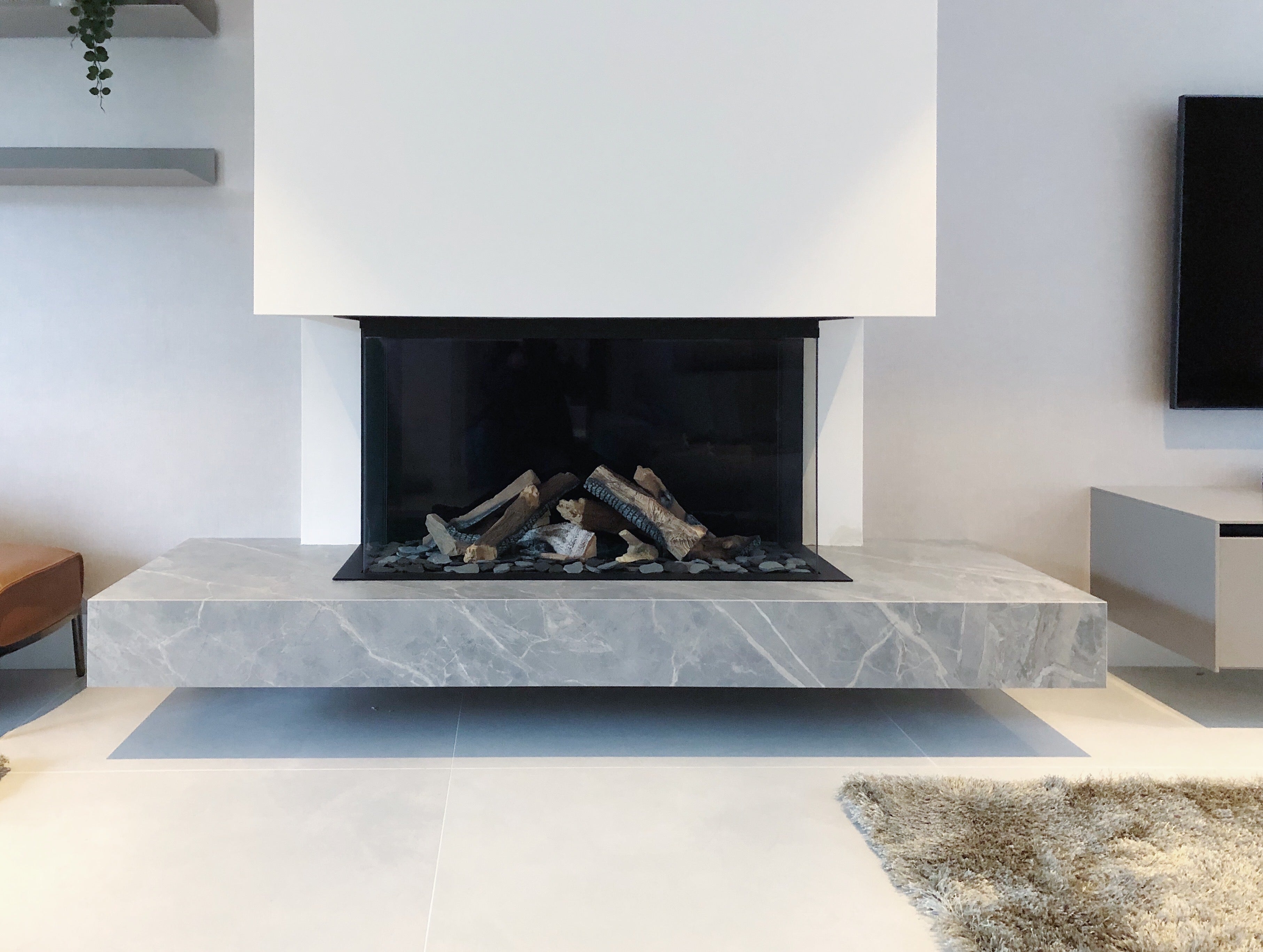 Porcelain raised fireplace and hearth