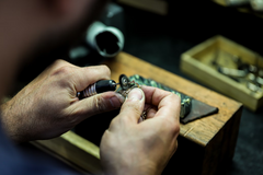 Jeweler repairing a piece of broken jewelry