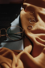 Rings and eyeglasses on a brown scarf
