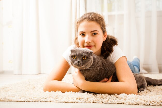 girl-is-huging-her-cat-they-are-lying-soft-carpet-room-cat-is-keeping-one-s-ears-open_290431-12815.jpg__PID:f2178385-39ee-43ad-9dee-0362e91acbbe