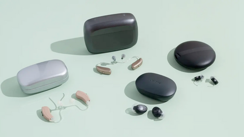 Four different models of over-the-counter hearing aids displayed side by side, with clear labels indicating their features and specifications.