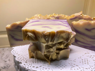 stack of purple and cream swirled bar of soap on a table