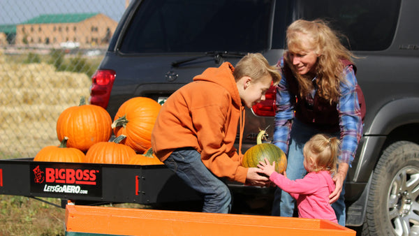 Kids putting pumpkins in BigBoss carrier