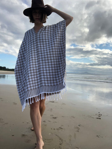 woman in bikini with beach towel that woks as tunic or dress and underlay walking along the beach in scott's head