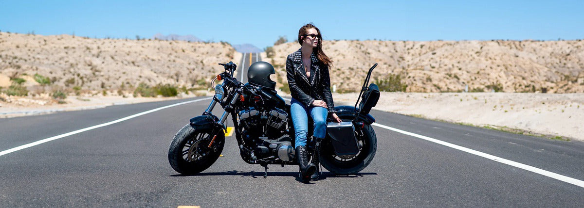 Female rider next to Harley-Davidson Sportster with Viking throw-over Saddlebags