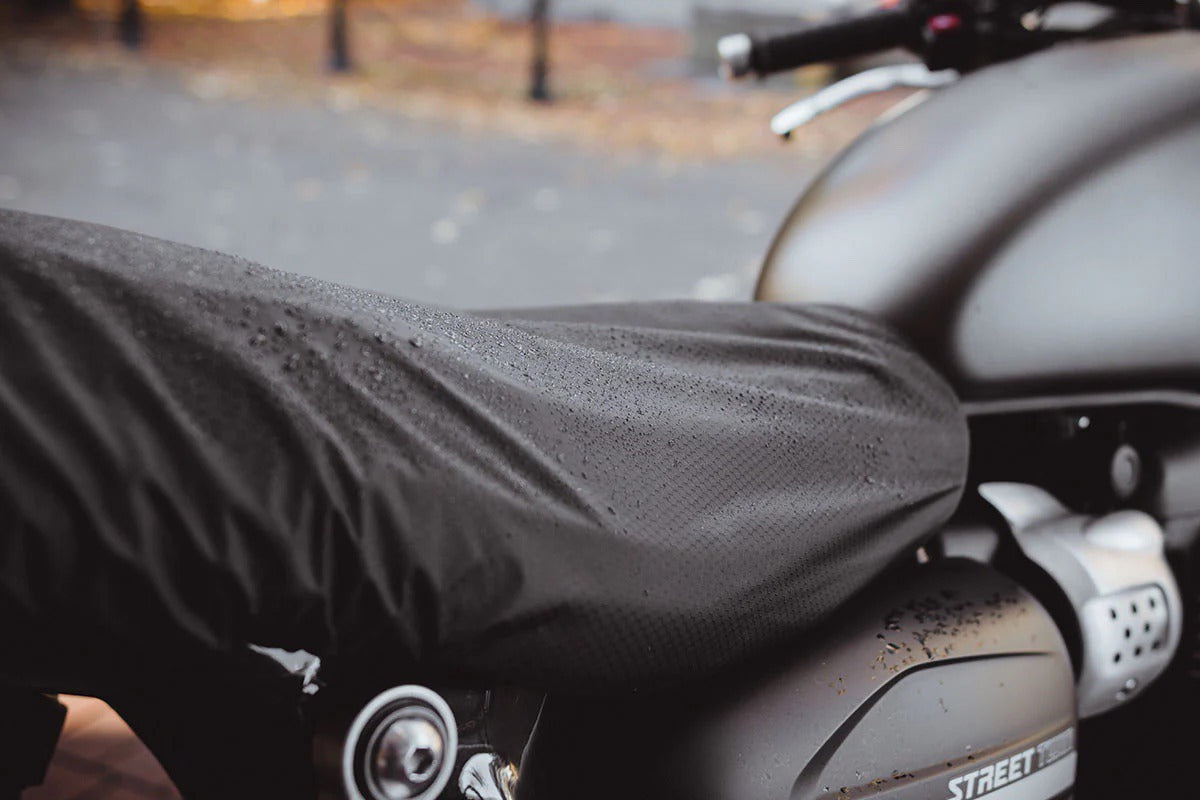 Luimoto weather protector covering seat of Triumph motorcycle