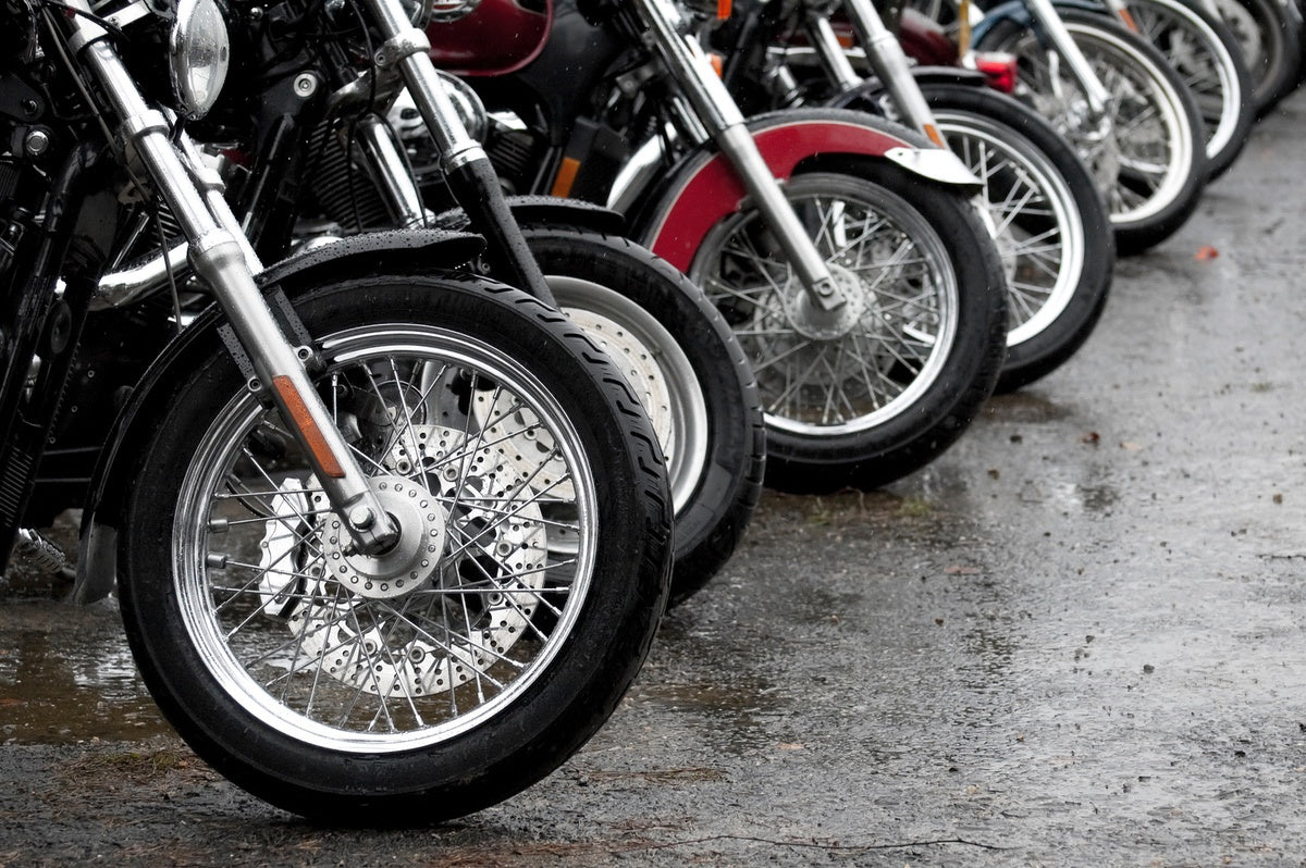 Motorcycle wheels and tires on street after rain