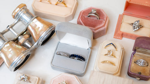 ring boxes with wedding pairings with engagement rings and vintage mother of pearl binoculars